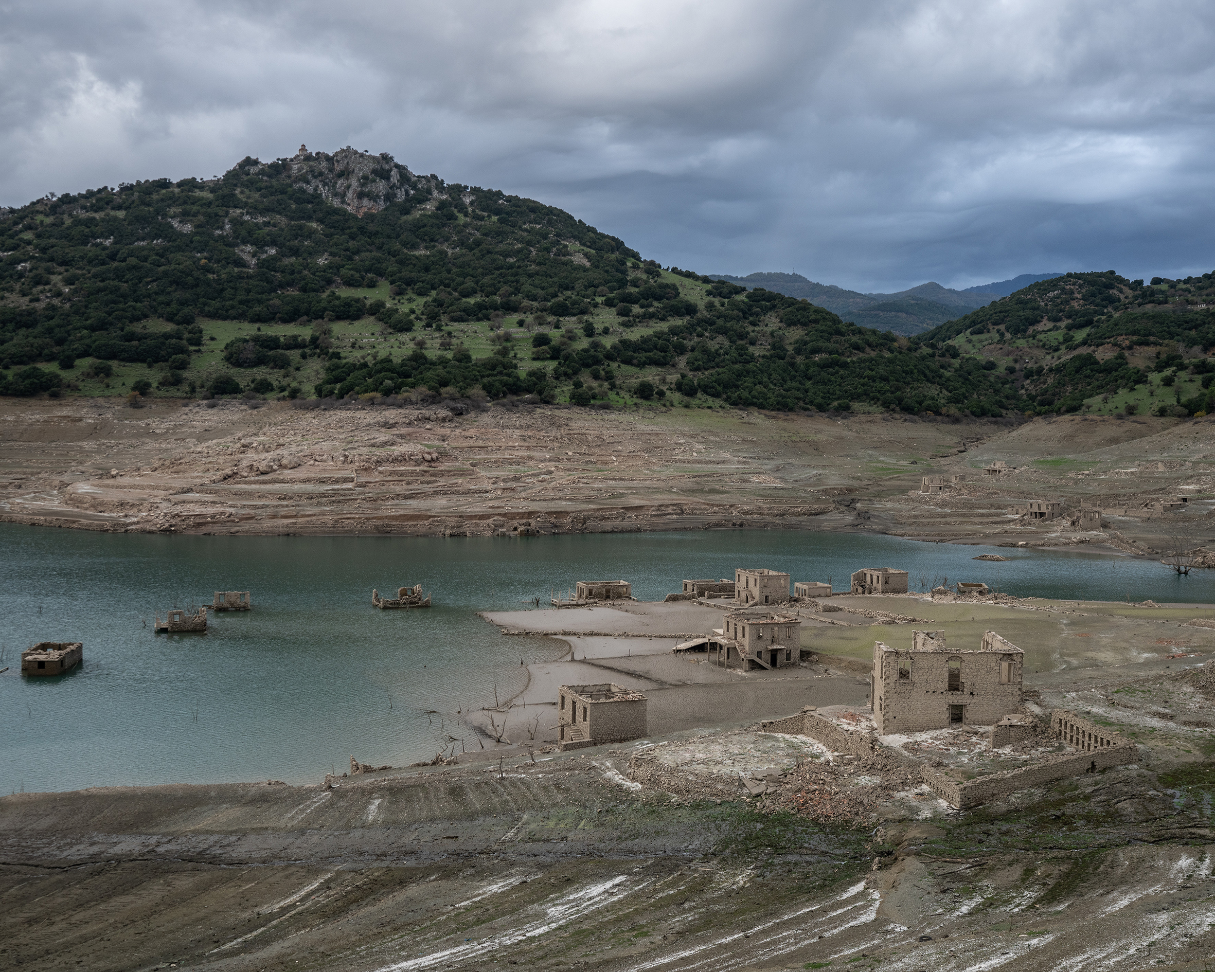 This photo shows the remnants of the houses that reappeared when the level of the Mornos artificial lake dropped following a drought, at the village of Kallio, about 240 km northwest of Athens, on November 3, 2025.